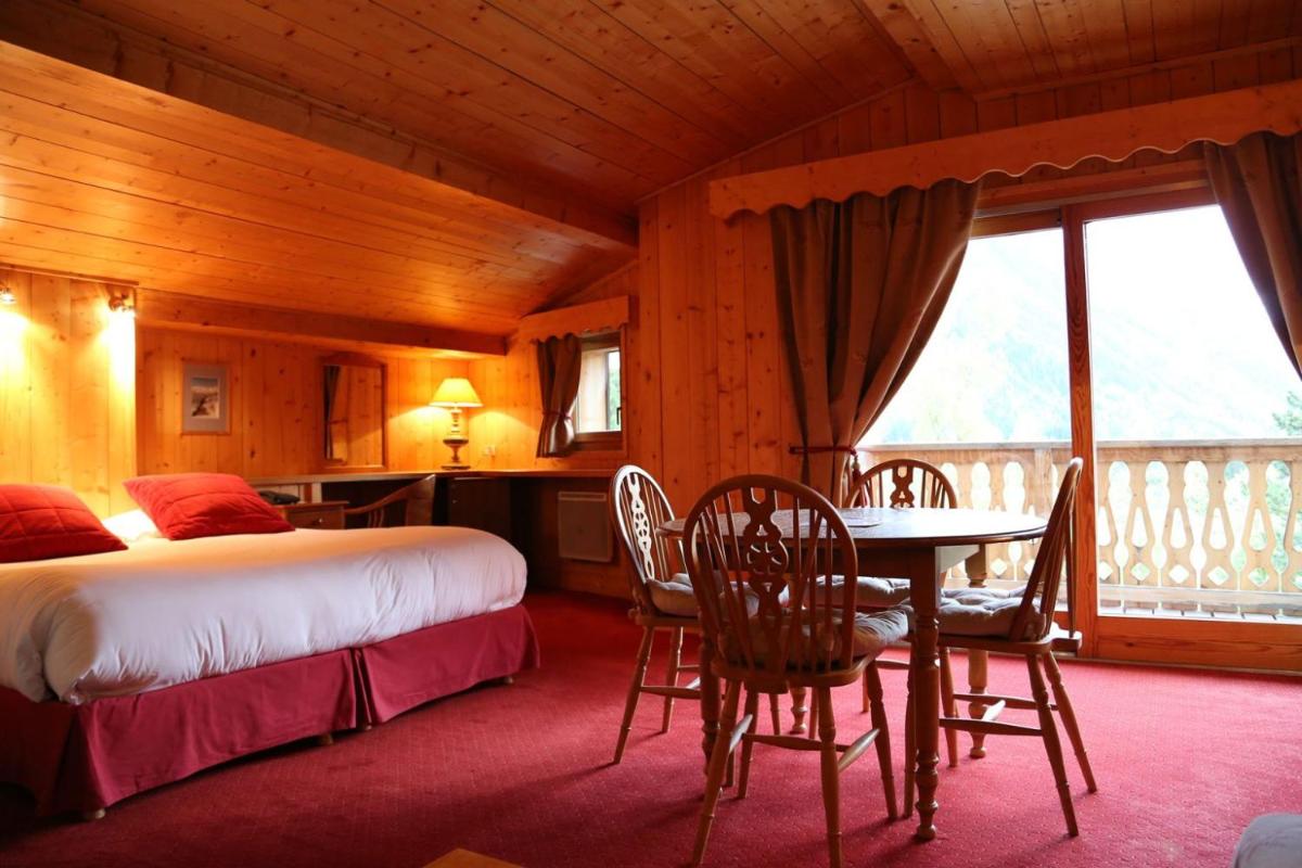 Un ou plusieurs lits dans un hébergement de l'établissement Hôtel Le Jeu de Paume