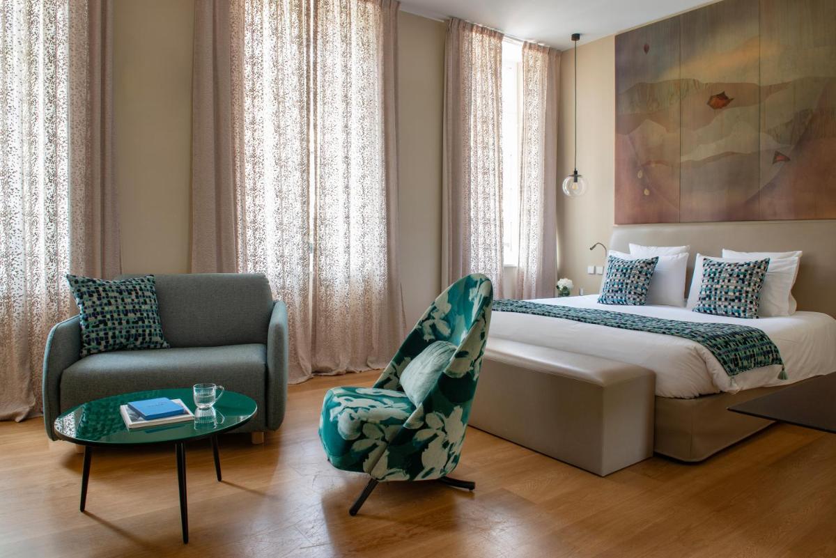 Un ou plusieurs lits dans un hébergement de l'établissement Hotel & Spa REGENT PETITE FRANCE