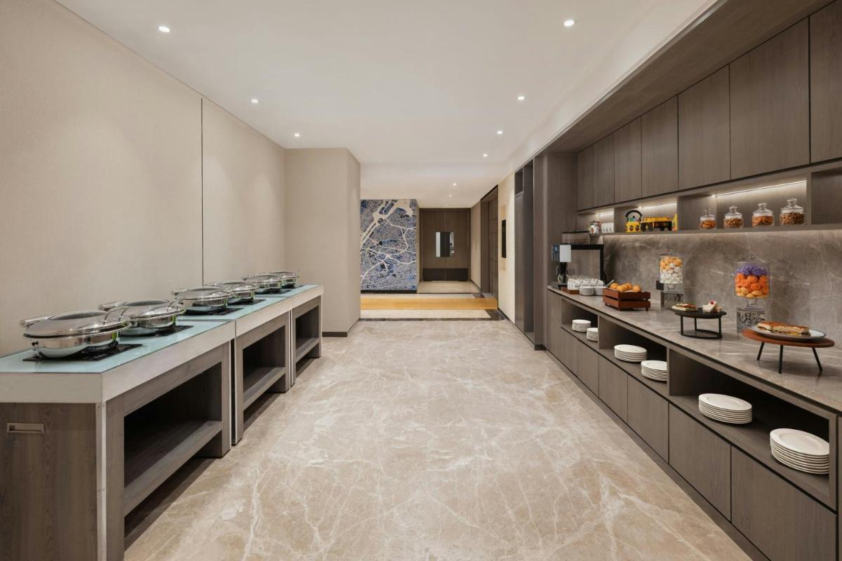 a large kitchen with a counter with pots and pans at Le Meridien Ahmedabad in Ahmedabad