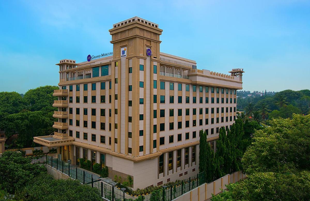 a building with a clock tower on top of it at Grand Mercure Mysore - An Accor Brand in Mysore
