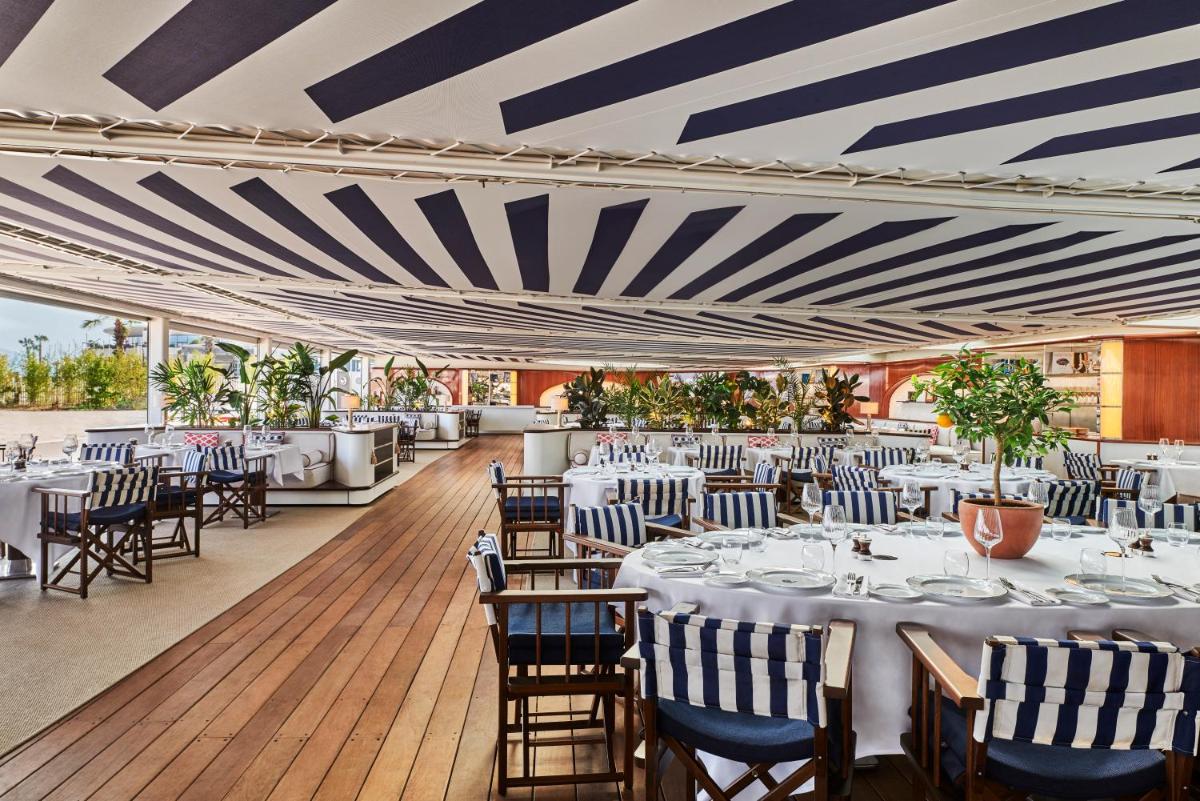 une salle à manger avec des tables et des chaises et un plafond rayé dans l'établissement Hôtel Barrière Le Majestic Cannes, à Cannes 37 autres photos