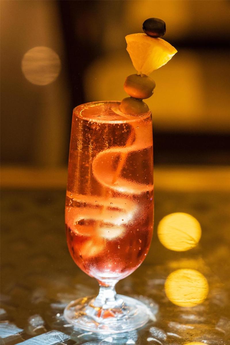 a drink in a glass sitting on a table at Radisson Goa Candolim in Candolim
