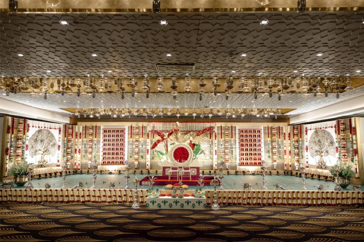 a large banquet hall with a pool in the center at Radisson Blu Hotel & Suites GRT Chennai in Chennai