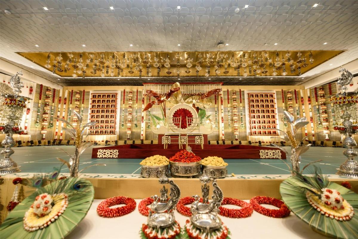 a room with a altar with red flowers on a table at Radisson Blu Hotel & Suites GRT Chennai in Chennai