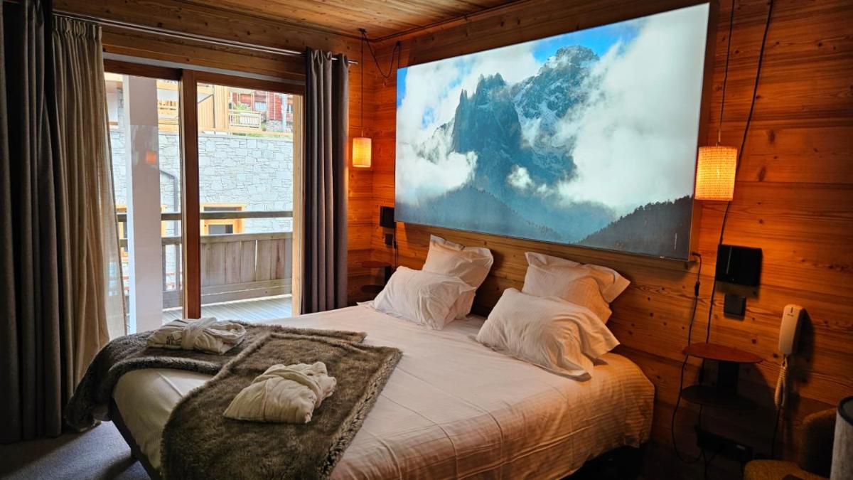Un ou plusieurs lits dans un hébergement de l'établissement Le Chalet Blanc Hôtel & Spa