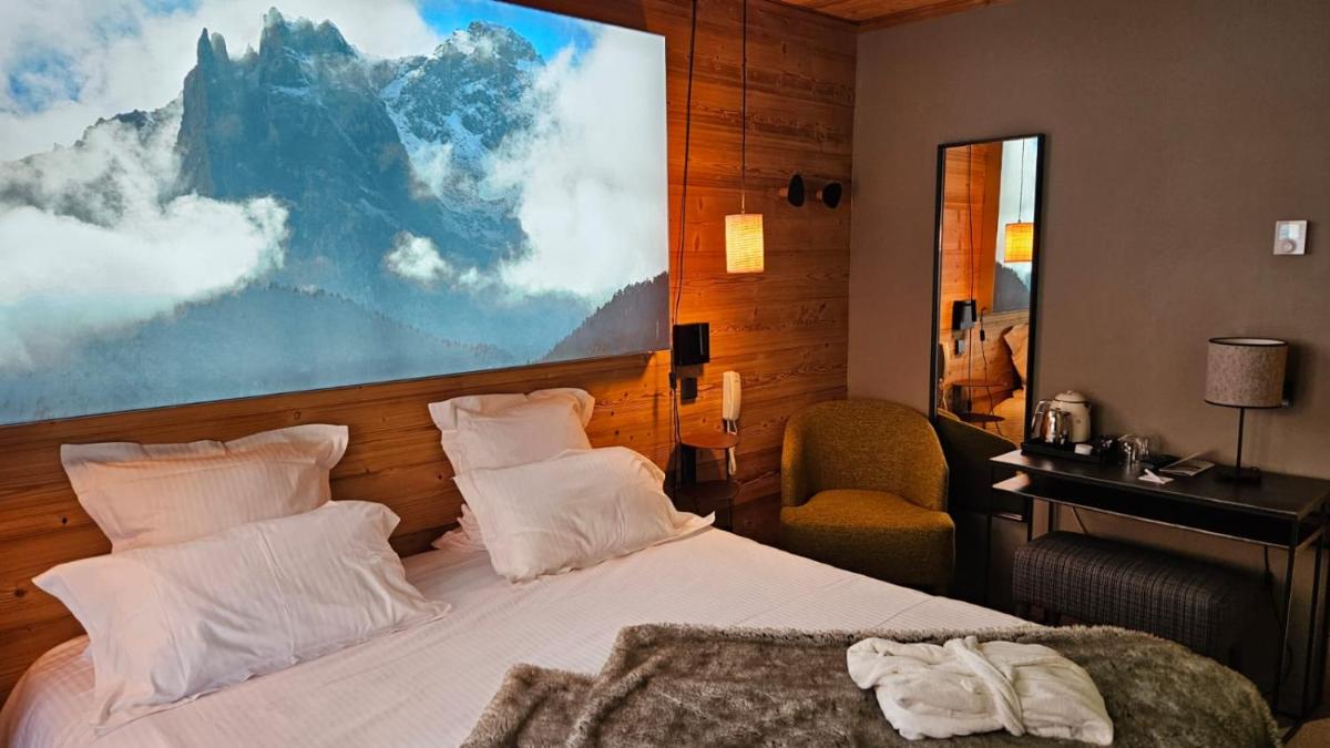 Un ou plusieurs lits dans un hébergement de l'établissement Le Chalet Blanc Hôtel & Spa