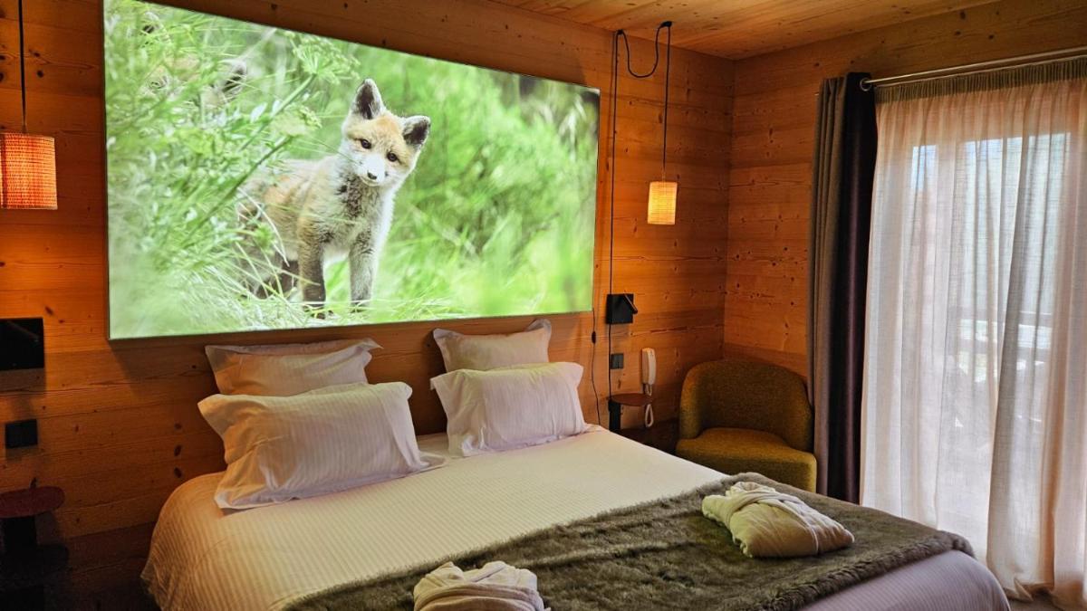 Un ou plusieurs lits dans un hébergement de l'établissement Le Chalet Blanc Hôtel & Spa
