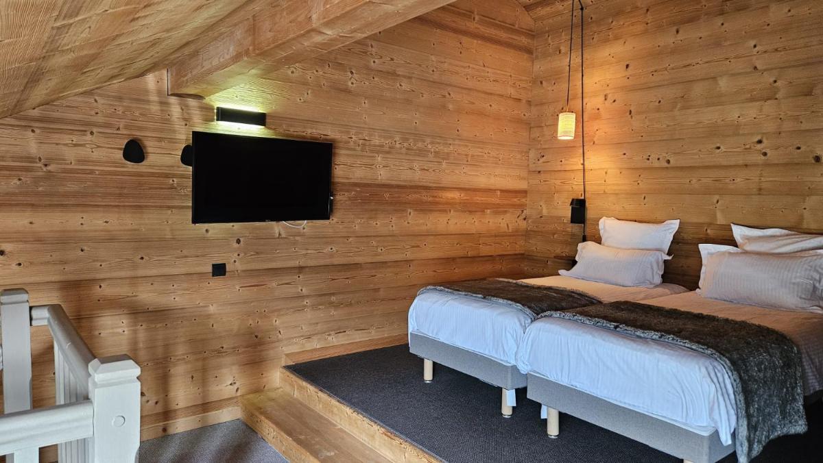 Un ou plusieurs lits dans un hébergement de l'établissement Le Chalet Blanc Hôtel & Spa