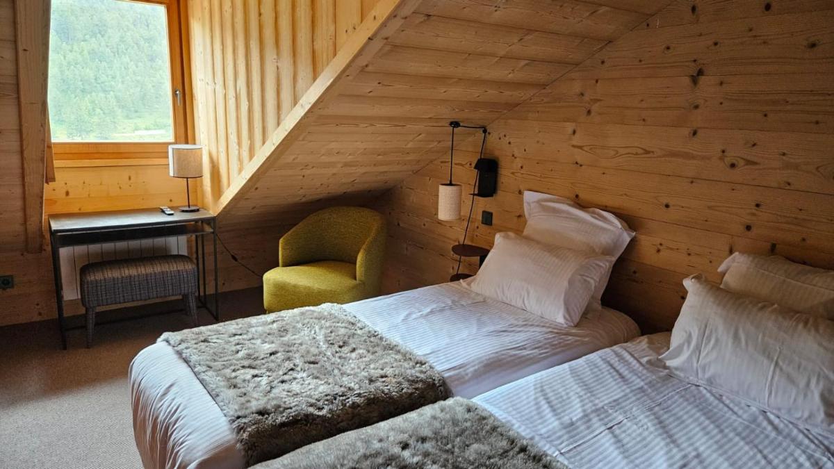 Un ou plusieurs lits dans un hébergement de l'établissement Le Chalet Blanc Hôtel & Spa