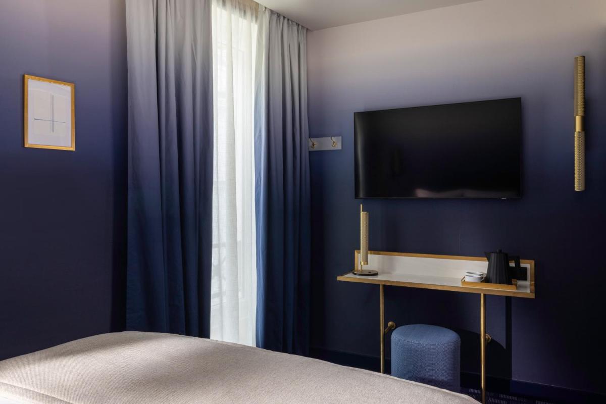 Télévision ou salle de divertissement dans l'établissement Hôtel Filigrane & Spa
