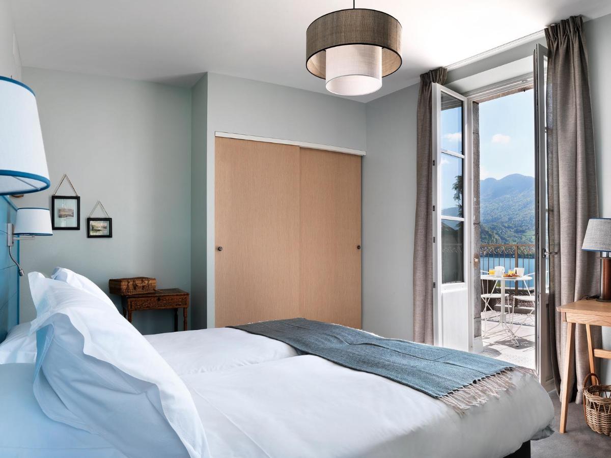 Un ou plusieurs lits dans un hébergement de l'établissement Hôtel Beau Site Talloires B SPA