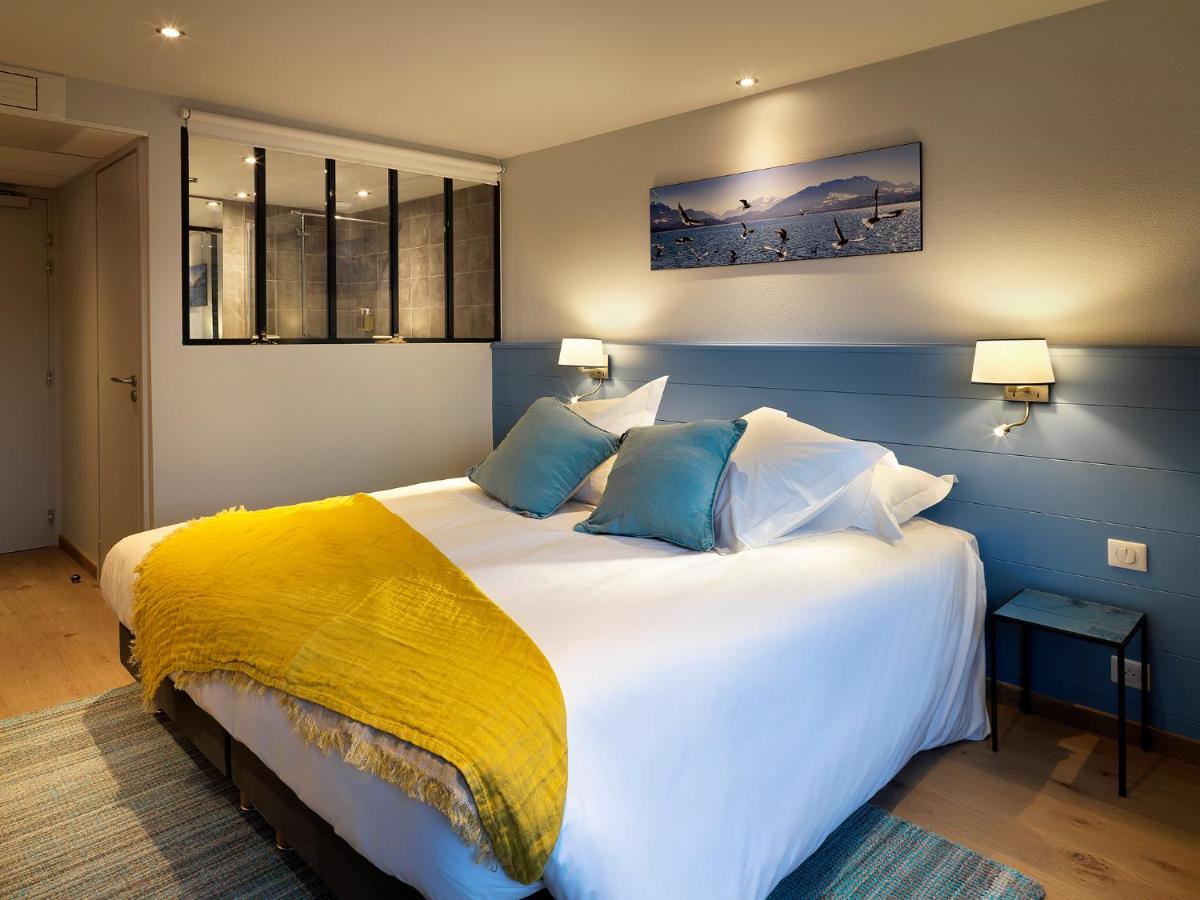 Un ou plusieurs lits dans un hébergement de l'établissement Hôtel Beau Site Talloires B SPA