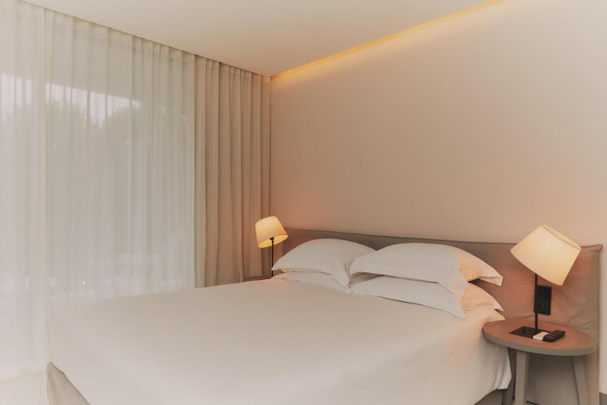 Un ou plusieurs lits dans un hébergement de l'établissement Hôtel Plage Palace & Spa