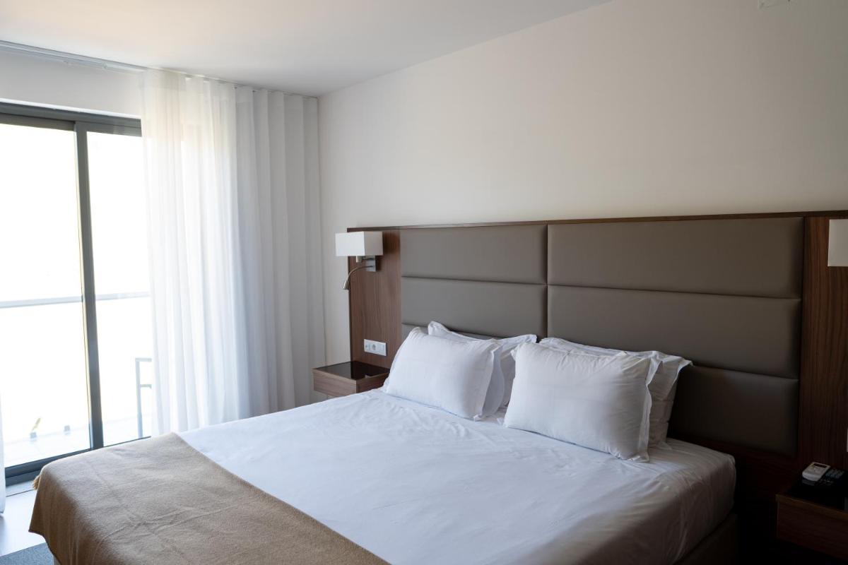 Uma cama ou camas num quarto em Hotel Freixo Douro Superior