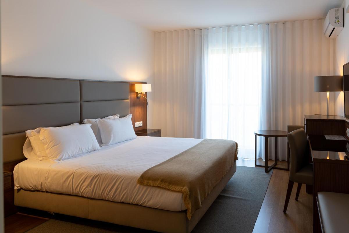 Uma cama ou camas num quarto em Hotel Freixo Douro Superior