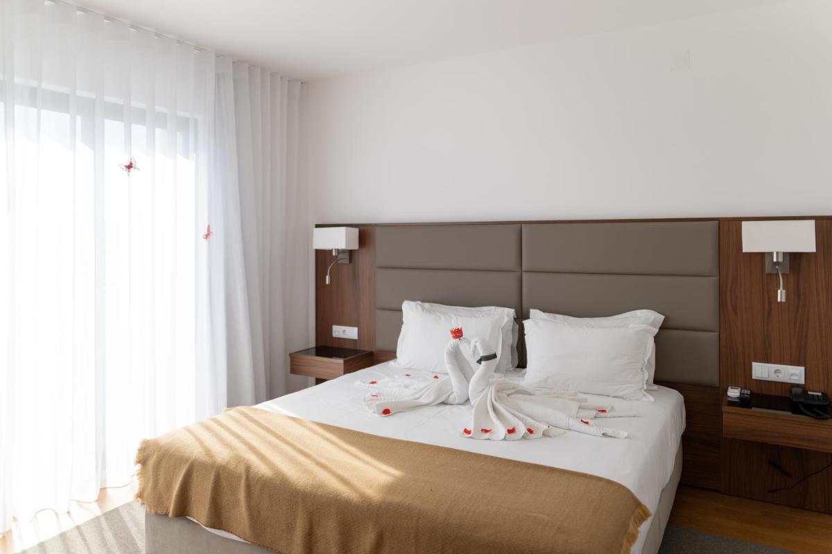 Uma cama ou camas num quarto em Hotel Freixo Douro Superior