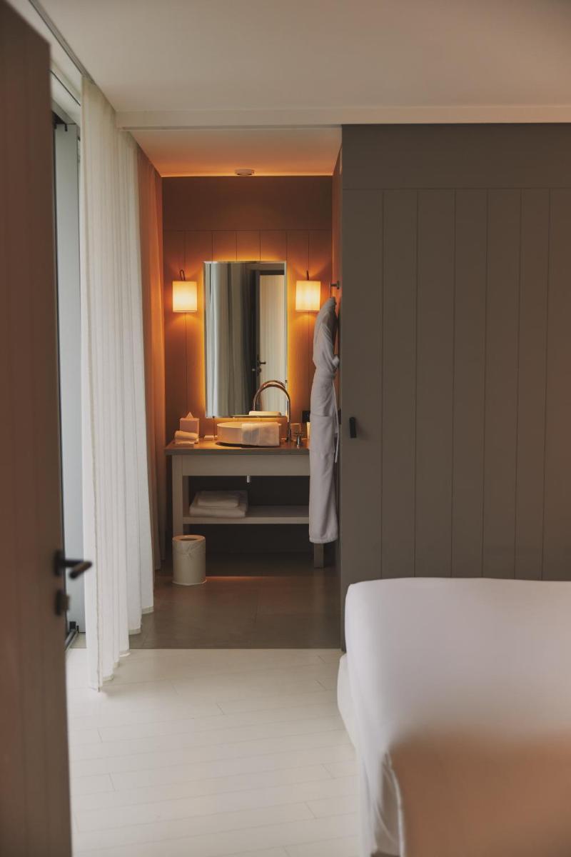 Un ou plusieurs lits dans un hébergement de l'établissement Hôtel Plage Palace & Spa