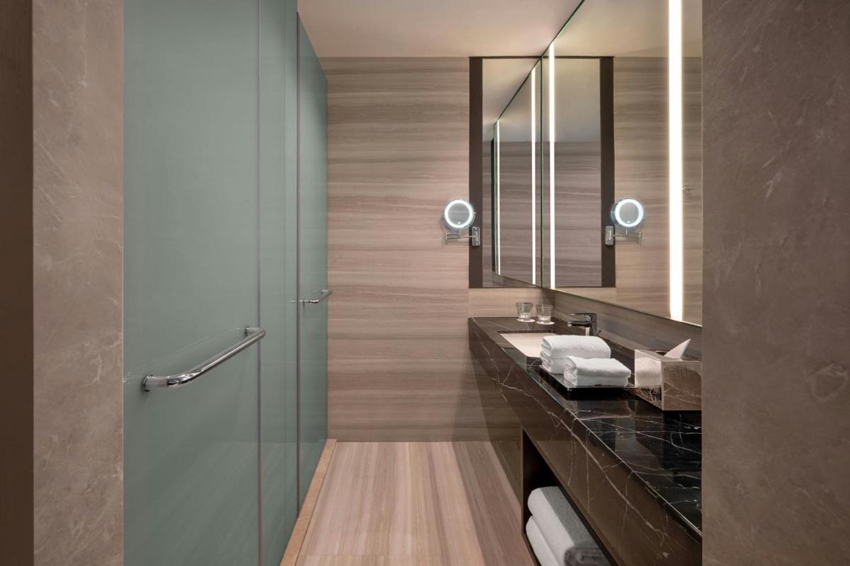 a bathroom with a sink and a mirror at Bengaluru Marriott Hotel Whitefield in Bengaluru