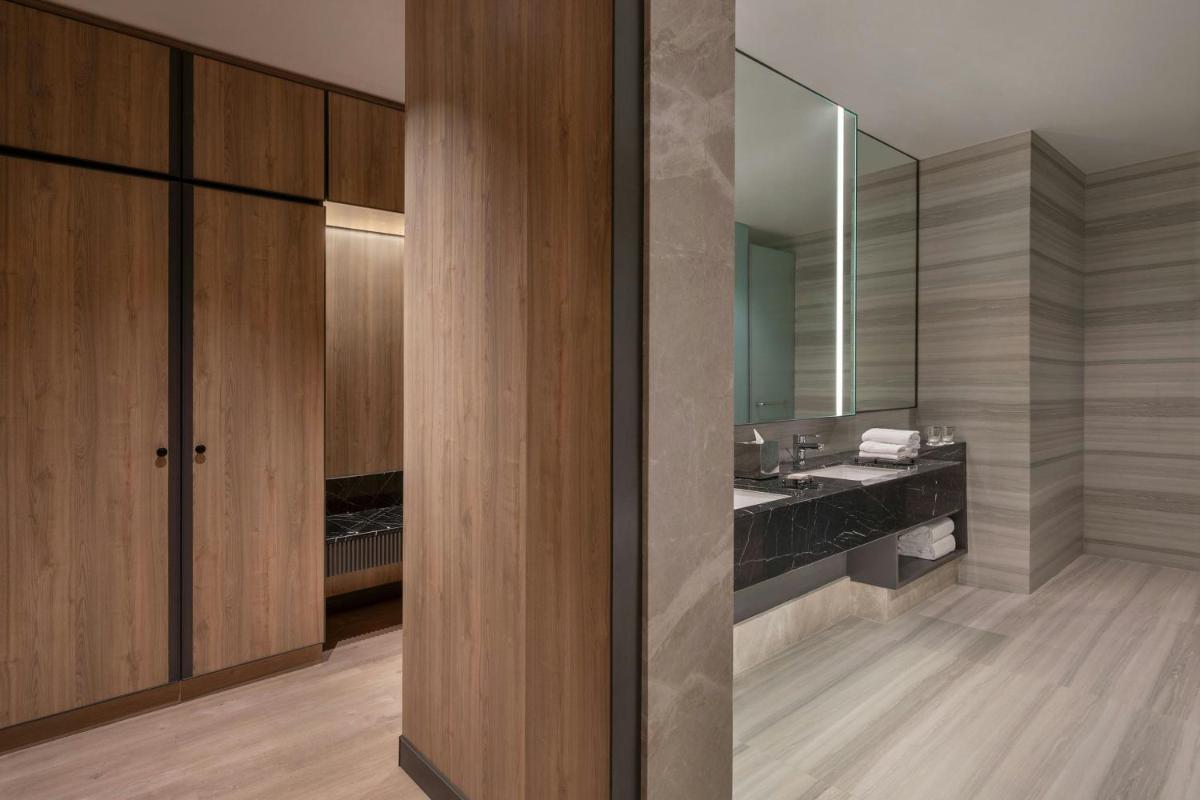 a bathroom with a sink and a mirror at Bengaluru Marriott Hotel Whitefield in Bengaluru