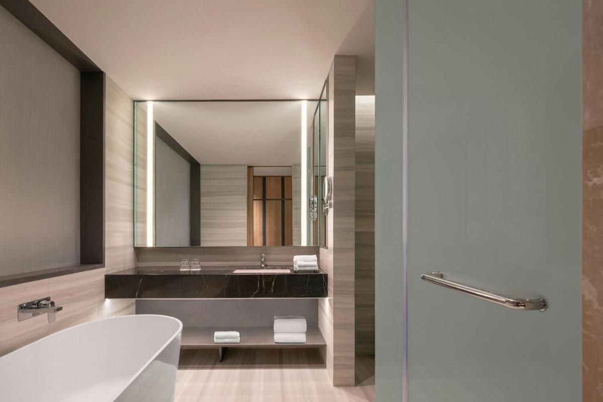 a bathroom with a sink and a mirror at Bengaluru Marriott Hotel Whitefield in Bengaluru
