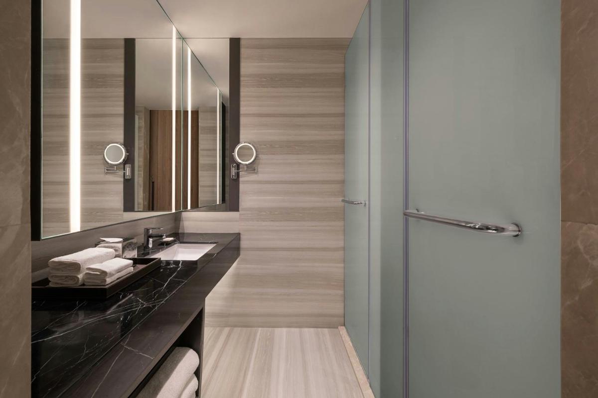 a bathroom with a sink and a mirror at Bengaluru Marriott Hotel Whitefield in Bengaluru