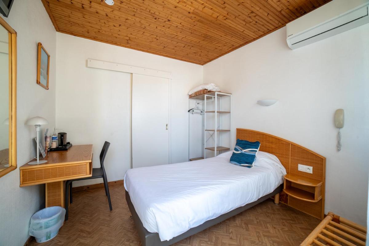 Un ou plusieurs lits dans un hébergement de l'établissement Hotel Les Dunes
