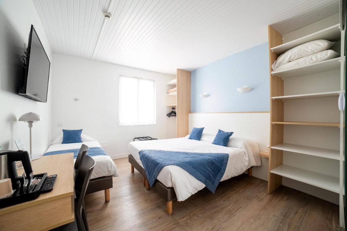 Un ou plusieurs lits dans un hébergement de l'établissement Hotel Les Dunes