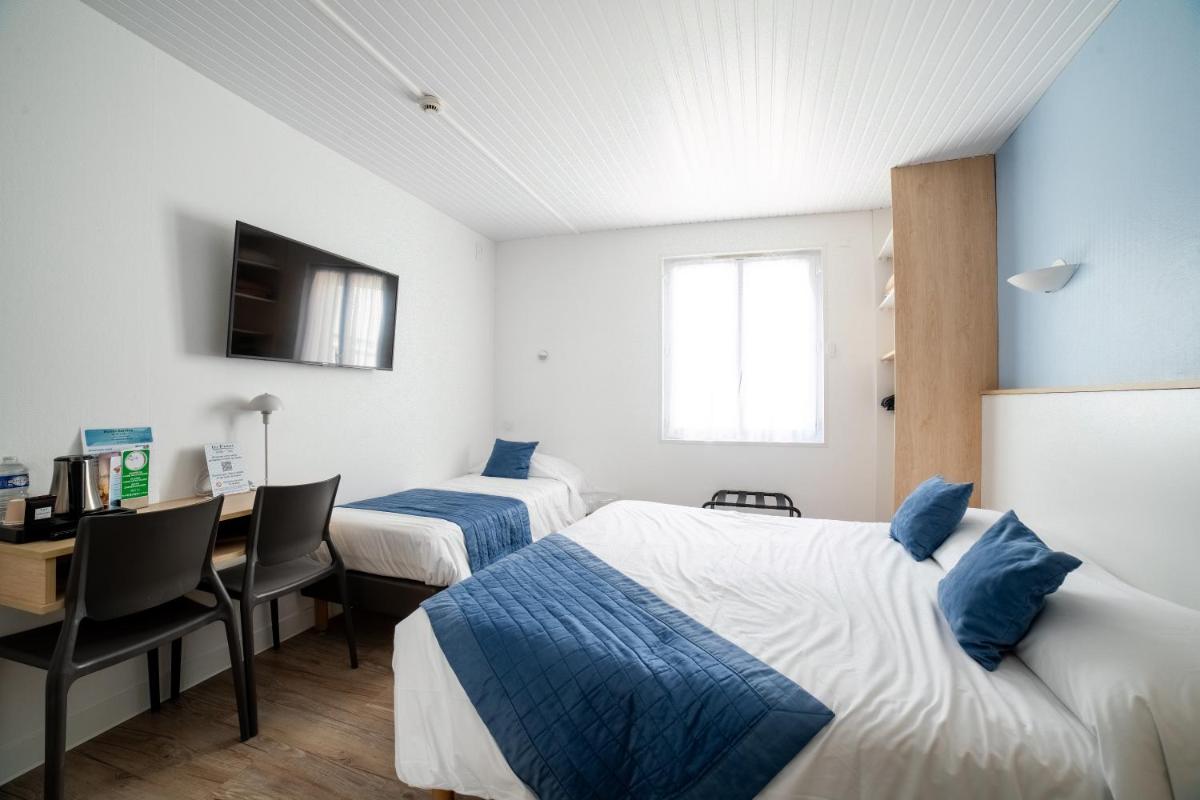 Un ou plusieurs lits dans un hébergement de l'établissement Hotel Les Dunes