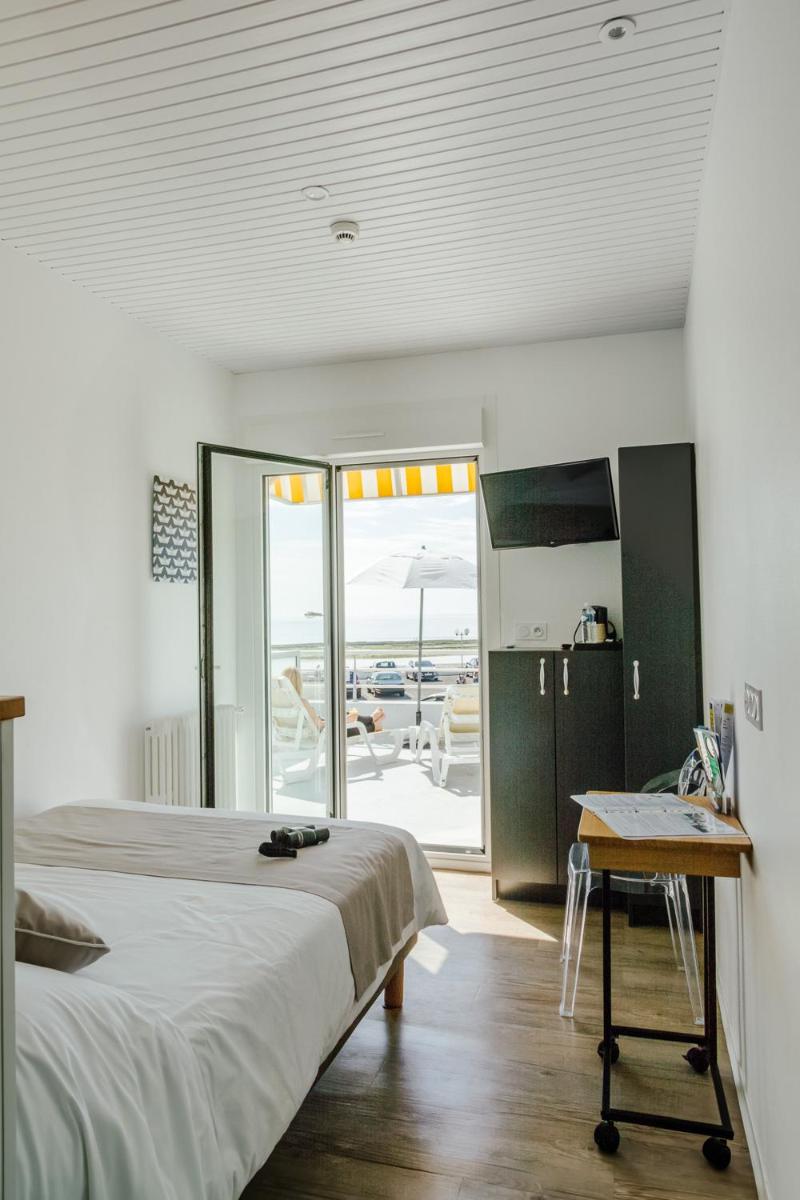 Un ou plusieurs lits dans un hébergement de l'établissement Hotel Les Dunes