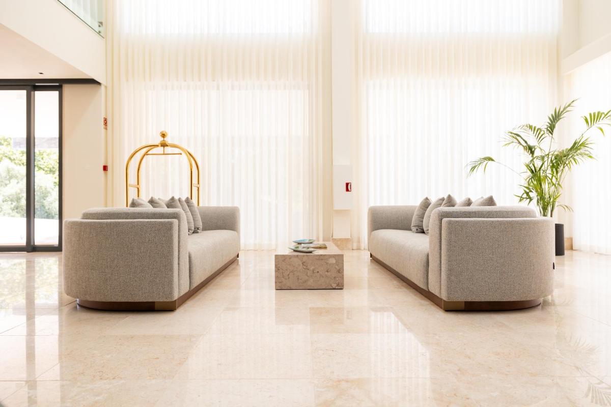 uma sala de estar com dois sofás e uma mesa em Quinta da Maquia Hotel em Sintra uma sala de estar com dois sofás e uma mesa em Quinta da Maquia Hotel em Sintra
