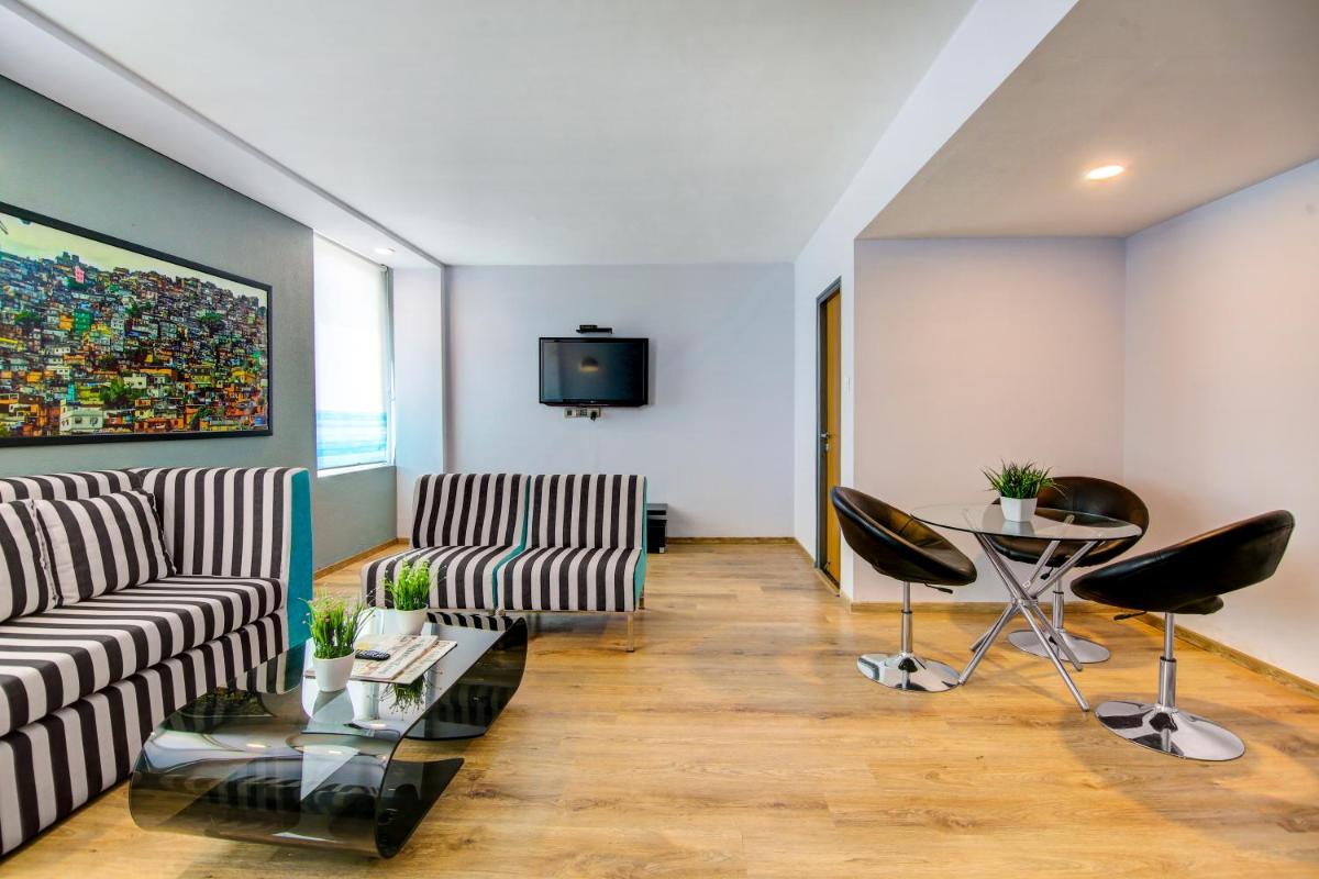 a living room with a couch and chairs and a table at Sunday Hotel Chandigarh Zirakpur in Zirakpur