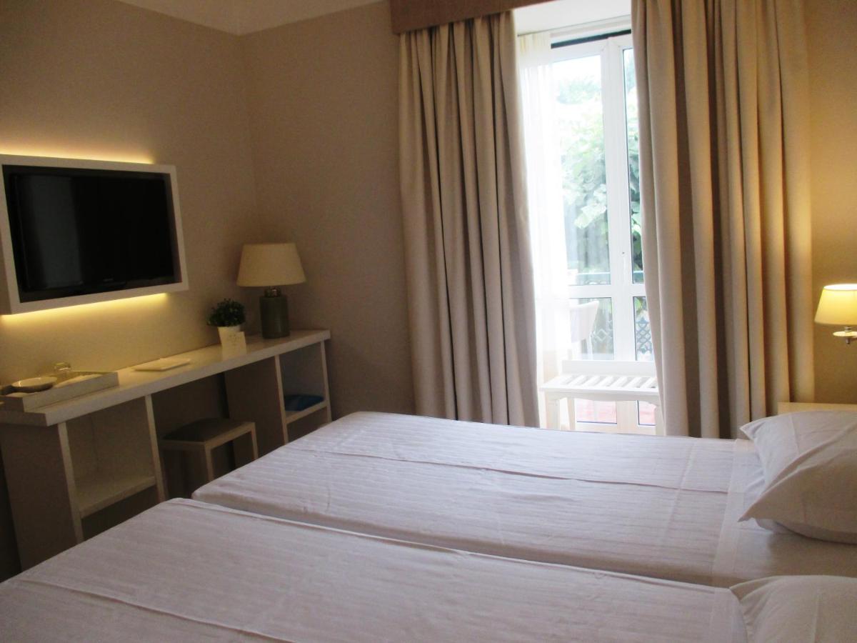 Uma cama ou camas num quarto em Grande Hotel das Caldas da Felgueira