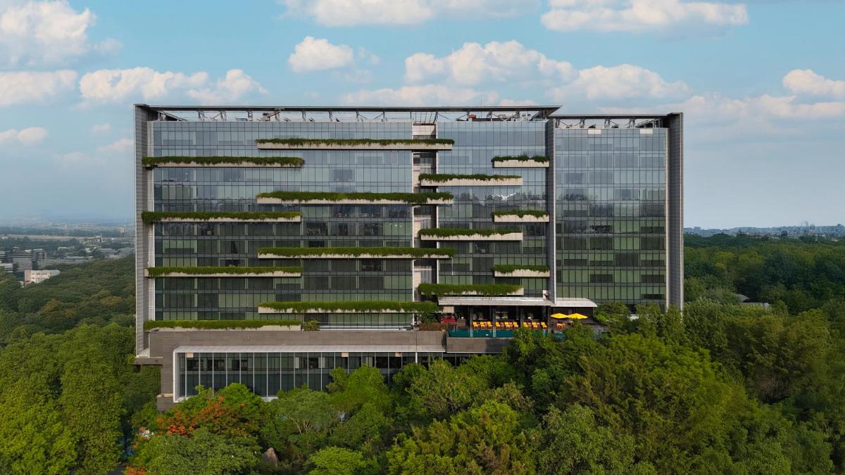 a tall building with plants on the side of it at Trident Hyderabad in Hyderabad