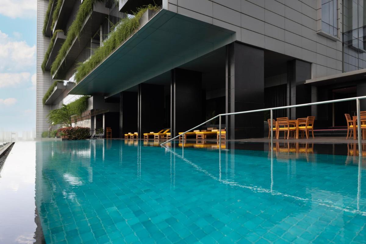 a swimming pool in front of a building at Trident Hyderabad in Hyderabad