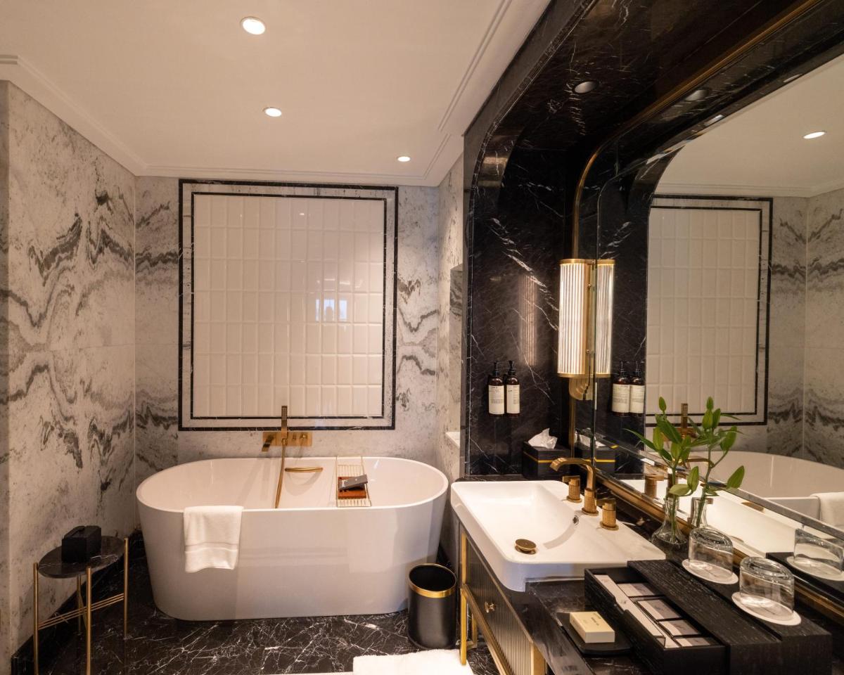 a bathroom with a large tub and a sink at Fairmont Mumbai in Mumbai