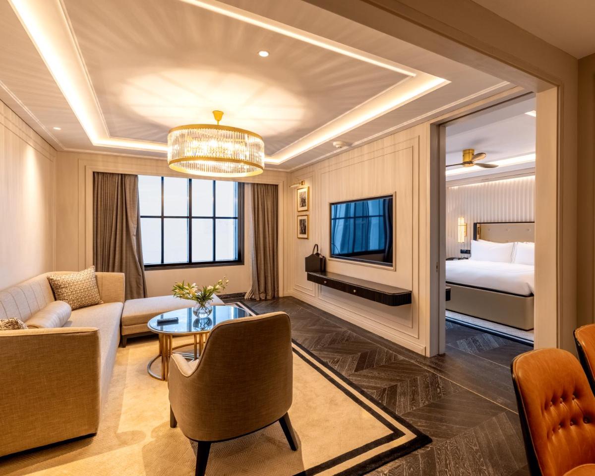 a living room with a couch and a bed at Fairmont Mumbai in Mumbai