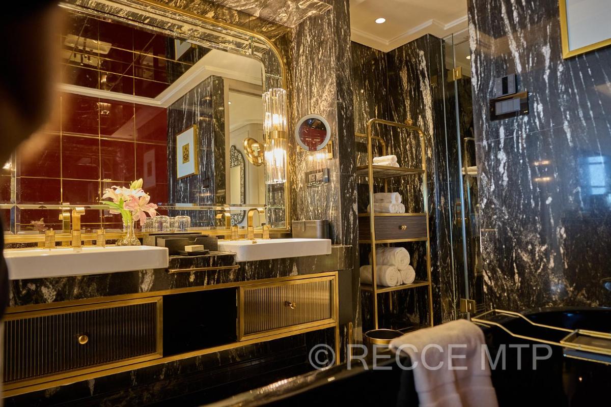 a bathroom with two sinks and a mirror at Fairmont Mumbai in Mumbai