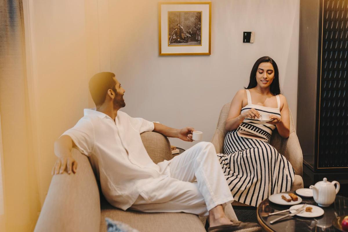 a man and a woman sitting on a couch at Fairmont Mumbai in Mumbai