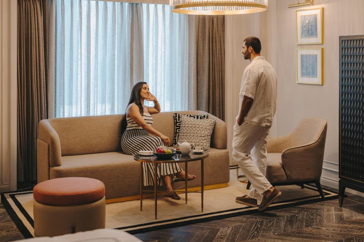 a man and a woman standing in a living room at Fairmont Mumbai in Mumbai