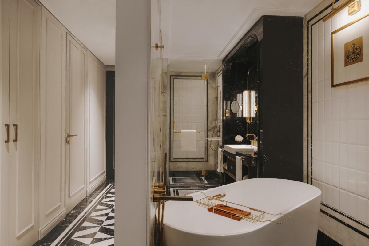 a bathroom with a white tub and a sink at Fairmont Mumbai in Mumbai
