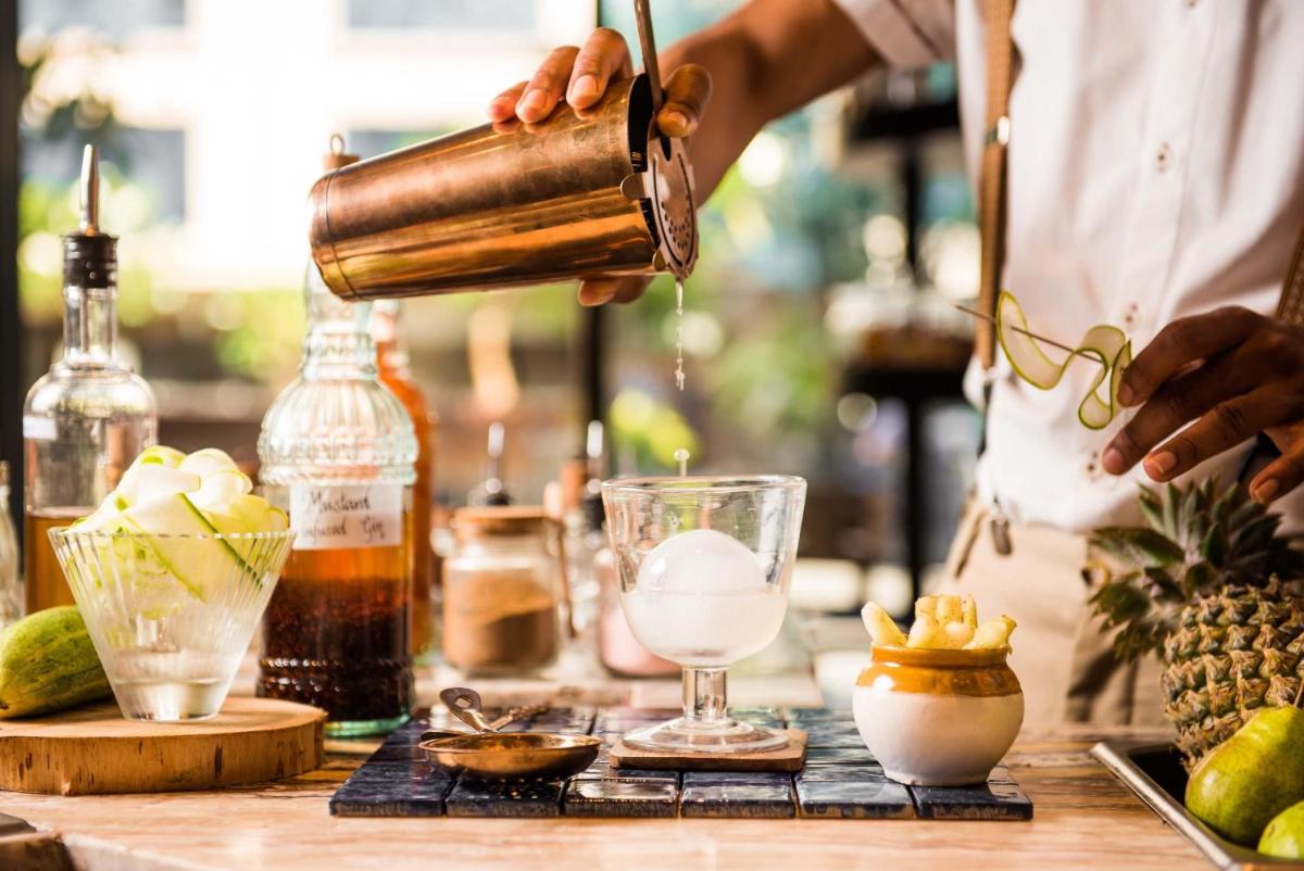 a man is making a drink in a bar at Hyatt Centric Candolim Goa in Calangute a man is making a drink in a bar at Hyatt Centric Candolim Goa in Calangute