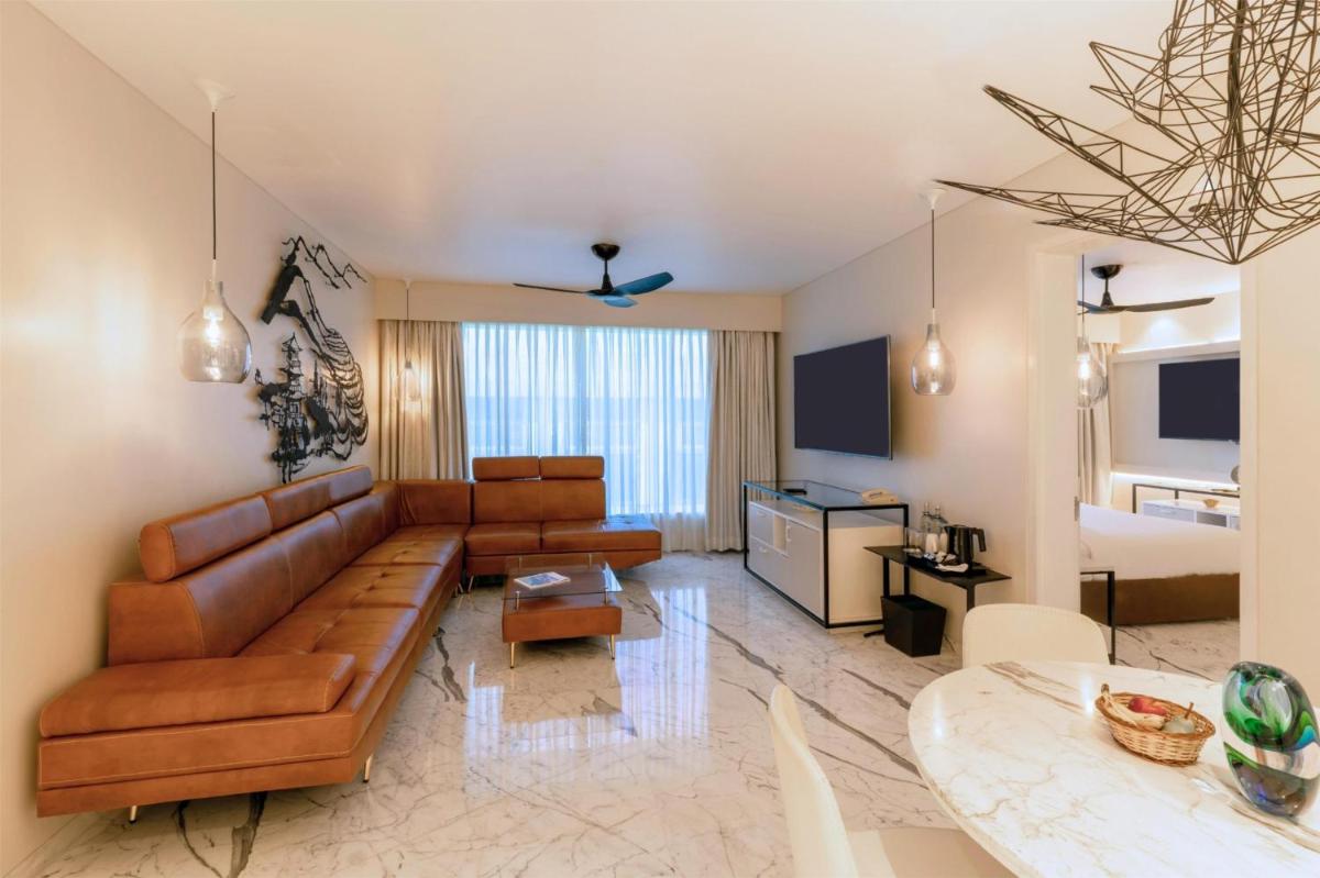 a living room with a couch and a table at Hyatt Centric Candolim Goa in Calangute a living room with a couch and a table at Hyatt Centric Candolim Goa in Calangute