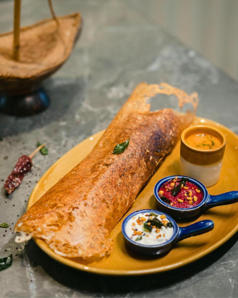 a plate of food with chapati and dips on a table at Hyatt Centric Candolim Goa in Calangute a plate of food with chapati and dips on a table at Hyatt Centric Candolim Goa in Calangute