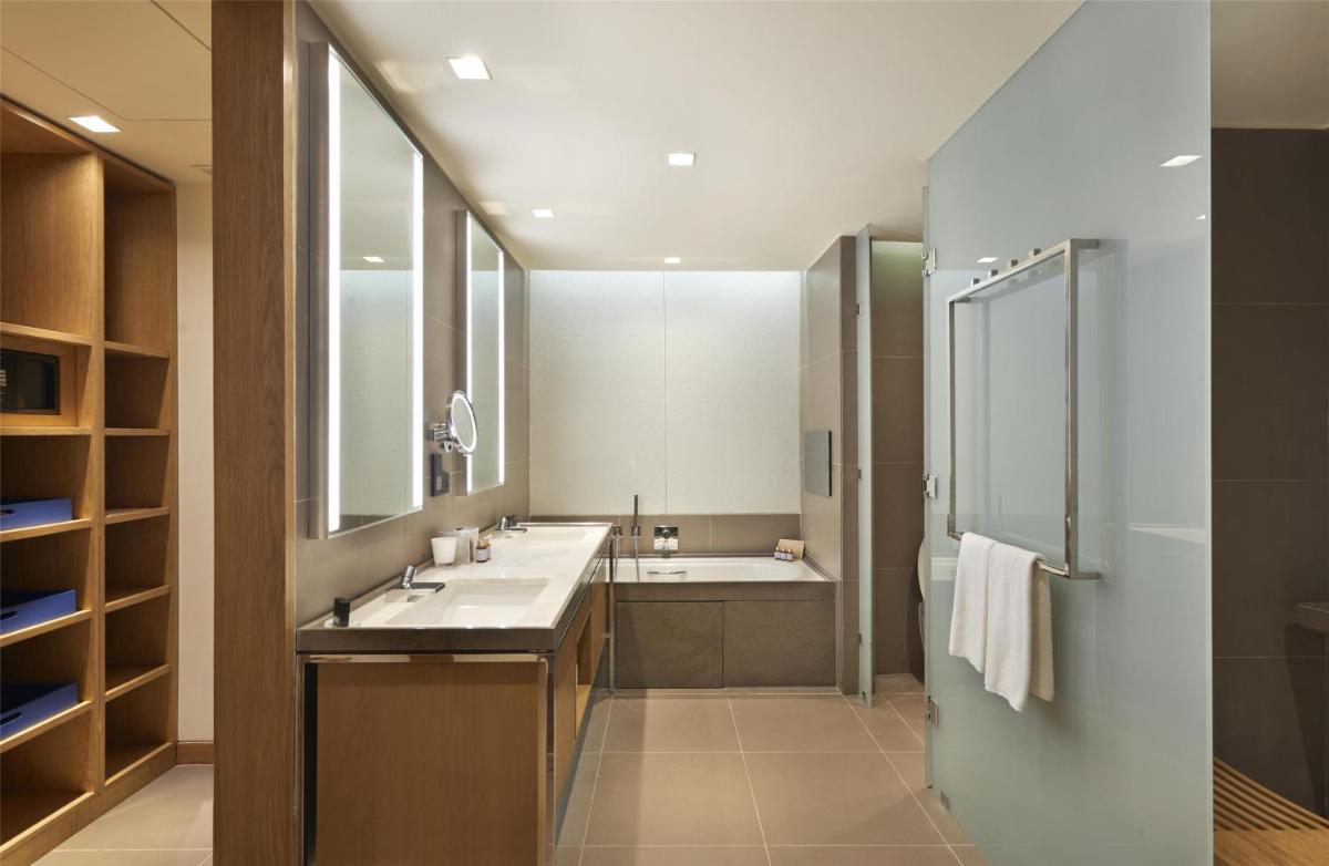 a bathroom with two sinks and a shower at Andaz Delhi, by Hyatt in New Delhi a bathroom with two sinks and a shower at Andaz Delhi, by Hyatt in New Delhi