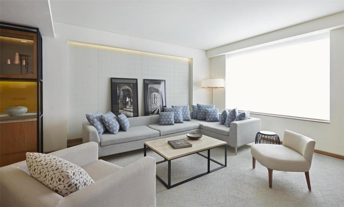 a living room with two couches and a table at Andaz Delhi, by Hyatt in New Delhi a living room with two couches and a table at Andaz Delhi, by Hyatt in New Delhi
