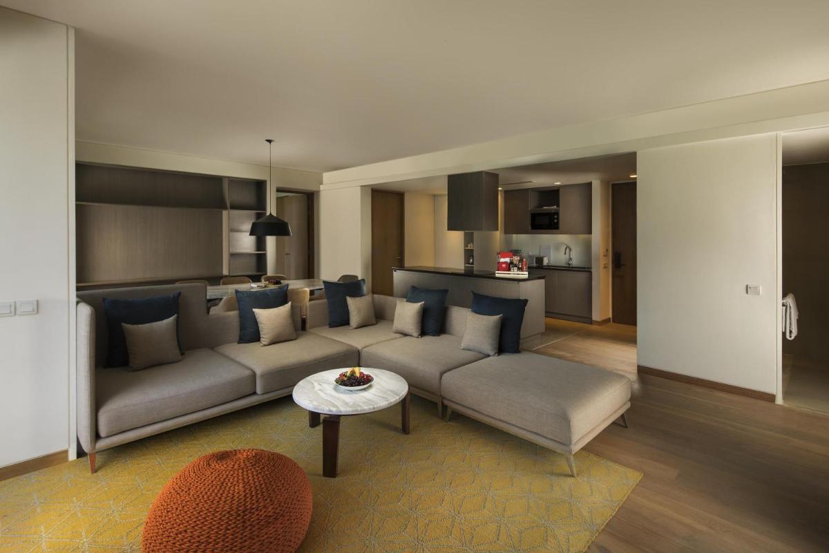 a living room with a couch and a table at Andaz Delhi, by Hyatt in New Delhi a living room with a couch and a table at Andaz Delhi, by Hyatt in New Delhi