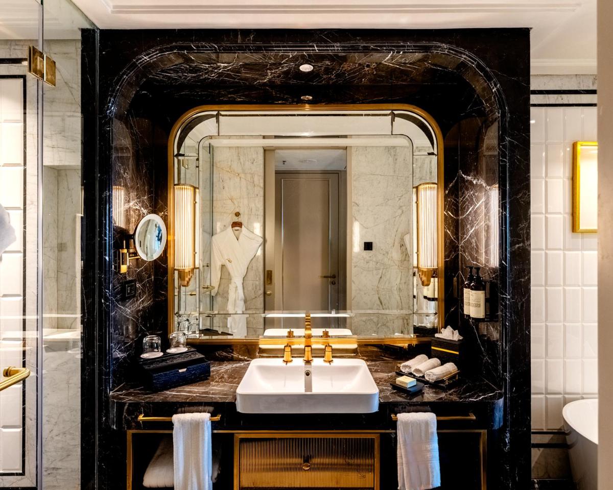 a bathroom with a sink and a large mirror at Fairmont Mumbai in Mumbai