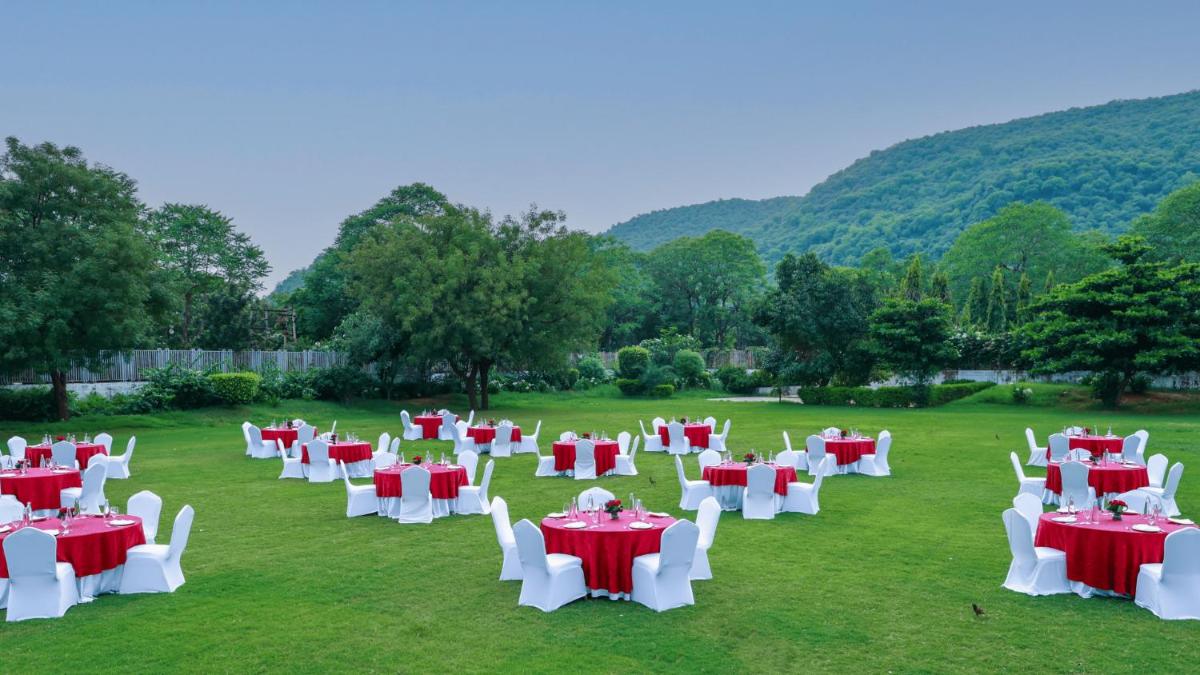 a field with red and white tables and chairs at DoubleTree By Hilton Jaipur Amer in Jaipur