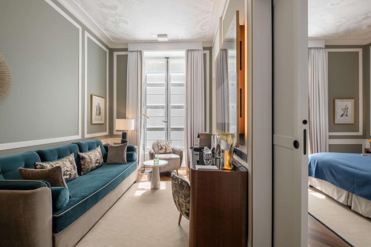Un ou plusieurs lits dans un hébergement de l'établissement Hôtel Les Lumières - Relais & Châteaux
