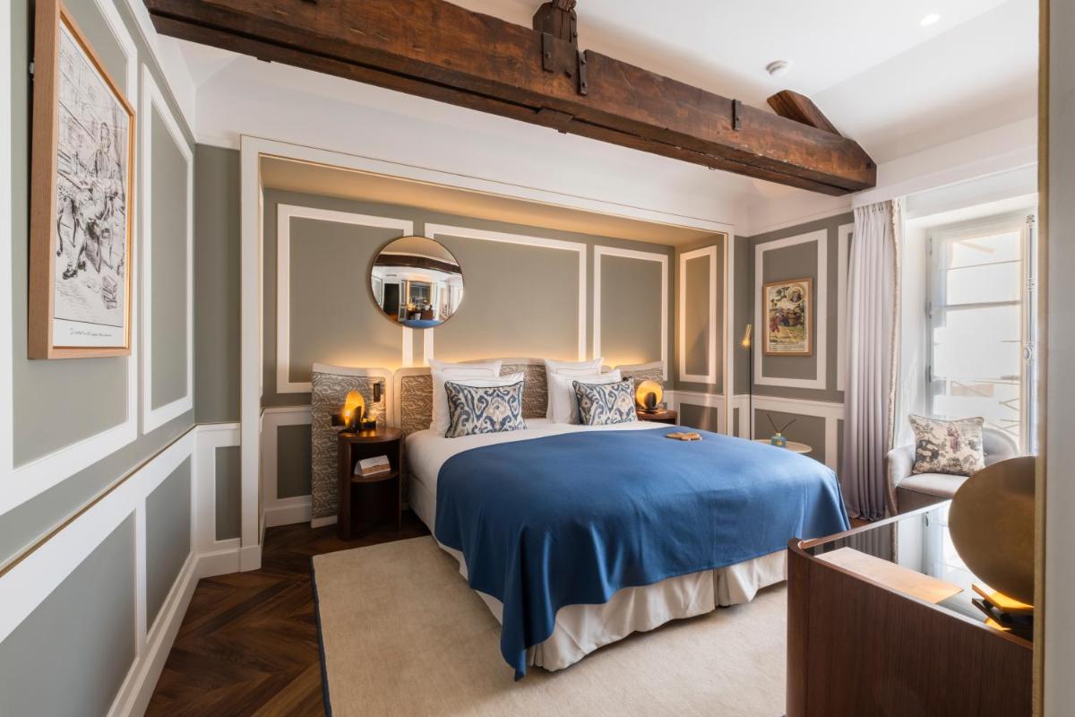 Un ou plusieurs lits dans un hébergement de l'établissement Hôtel Les Lumières - Relais & Châteaux